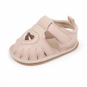 Pink heart-cutout baby walking sandals with breathable design and velcro strap
