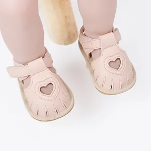 Detailed close-up view of pink infant summer sandals featuring heart shaped cutout designs