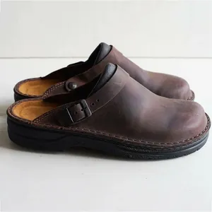 Vintage dark brown leather clogs with adjustable buckle strap and thick black sole