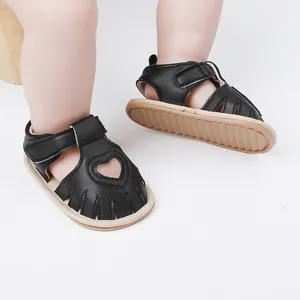 Detail of black infant walking sandals with heart cutout for 0-1 year old babies