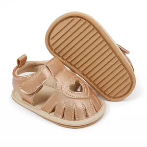 Detailed view of metallic gold baby sandals with heart cutout and anti-slip rubber sole