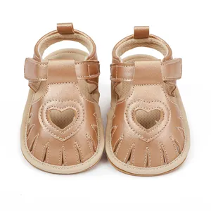 Rose gold infant walking sandals with heart cutout design and secure Velcro strap