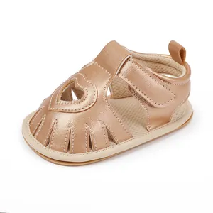 Close-up view of a rose gold baby walker sandal with heart cutout and soft sole detail