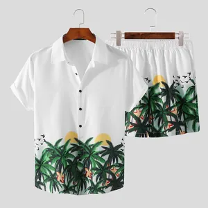 Detail view of men's summer beach set featuring tropical palm tree print on white fabric.
