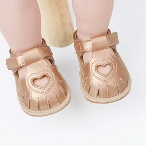 Close-up of rose gold baby summer sandals featuring a delicate heart-shaped cutout design