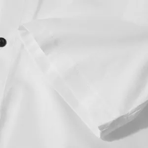 Close-up detail of white men's beach shirt sleeve with clean stitching and black button