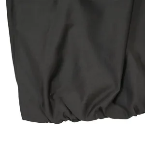 Detailed macro view showing elastic hem and soft fabric texture of a black bodycon dress