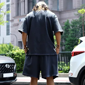 Vista trasera de un hombre con un conjunto de camiseta y pantalones cortos gris carbón
