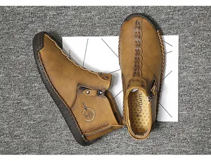 Detailed top view of brown handmade men's high-top leather boots with side zipper