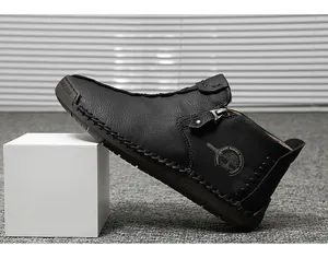Side view of black handmade high-top men's leather shoes with side zipper detail.