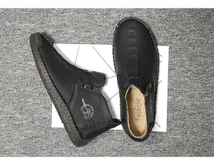 Detailed top view of black men's high-top leather shoes with side zipper and logo