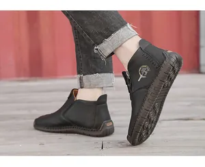 Side view of men's black pebbled leather high-top boots with durable rubber sole