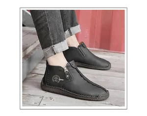 Detail view of men's black high-top leather shoes with a side zipper and textured finish.