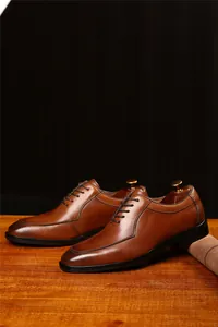Primer plano de zapatos Oxford de cuero marrón con estilo vintage británico en madera