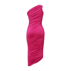 Detailed view of magenta one-shoulder ruched bodycon dress with asymmetrical hem