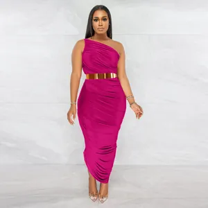 Fuchsia one-shoulder ruched bodycon maxi dress with a metallic gold belt accessory.