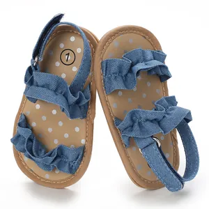Detailweergave van blauwe denim babysandalen met ruches en gestippelde inlegzolen