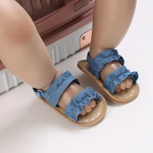 Detailopname van blauwe denim baby sandalen met ruffles en antislip stippen zolen