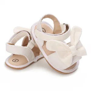White baby girl sandals with large bow detail and velcro strap for summer