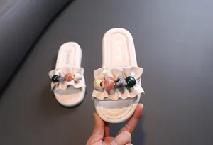 Girls' white summer slippers featuring ruffled trim and colorful decorative beads