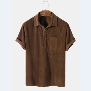 Close-up detail of a brown corduroy short sleeve shirt with chest pocket and collar