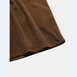 Close-up macro view showing the fine striped texture of brown corduroy shirt fabric