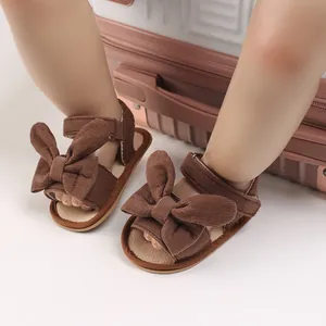 Infant girl's brown corduroy sandals with large bow detail and velcro soft sole design