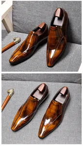 Detailed view of high-quality polished brown hand-rubbed leather loafers on grey armchair