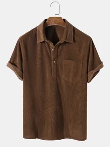 Close-up detail of brown men's corduroy short sleeve polo shirt featuring texture and pocket