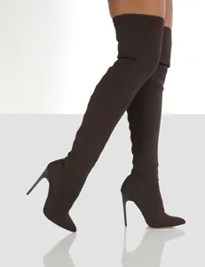 Detail view of brown knitted over-the-knee sock boots with pointed toe and stiletto heel