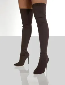 High-quality macro view of dark brown knitted over-the-knee sock boots with stiletto heels