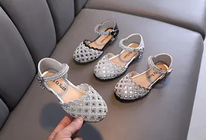 Macro view showing rhinestone-encrusted cutout princess shoes for girls with elegant pearls