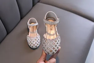 Detailed view of elegant pink girls' princess shoes with pearls and rhinestones