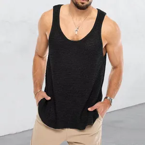 Detail view of a men's black loose knitted tank top with high-quality textured weave.
