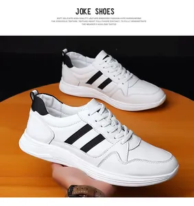 Close-up detail showing white leather sneakers with black stripes on wooden table