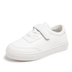 Detailed side view of pure white children's casual sneakers with secure velcro strap.