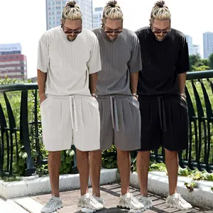 Three colors of men's casual pleated shorts and t-shirt sets in an outdoor setting