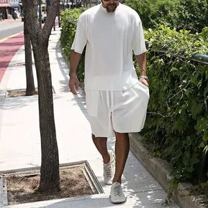 Detailed view of men's white pleated summer two-piece set with a loose fit texture