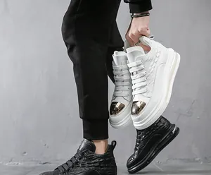 Close-up detail of premium leather high-top sneakers with embossed crocodile texture