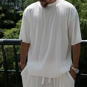 Close-up detail of white vertical pleated men's casual short sleeve and shorts set
