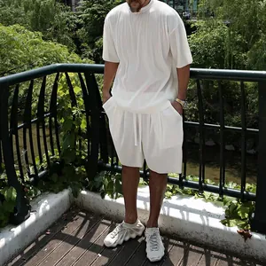 Detailed view of the pleated texture on a men's white casual short sleeve set.