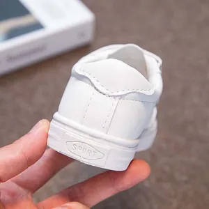 Classic white children's sports shoes with a durable rubber sole and heel detail