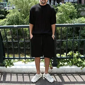 Full view of men's black vertical striped t-shirt and shorts casual set on model outdoors