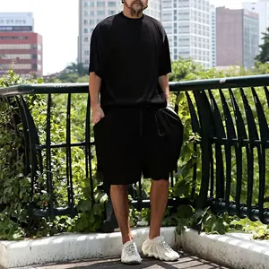 Outdoor street style view of men's black ribbed short sleeve and shorts set