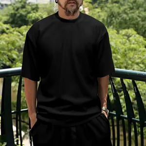 Detailed macro view of men's black ribbed short sleeve casual t-shirt and shorts set.