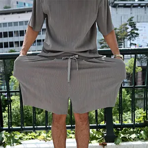 Detailed rear view of men's grey vertical pleated casual set showing fabric elasticity