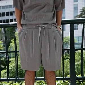 Detailed view of grey vertical pleated texture on casual summer men's short-sleeve suit