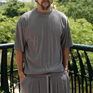 Detailed macro view showing the vertical pleated texture of men's gray casual summer set