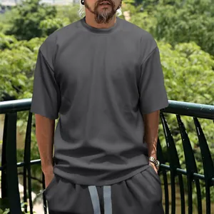 Detail view of men's dark grey vertical ribbed casual T-shirt and shorts set