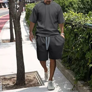 Men's grey t-shirt and shorts tracksuit set shown in an outdoor urban street setting
